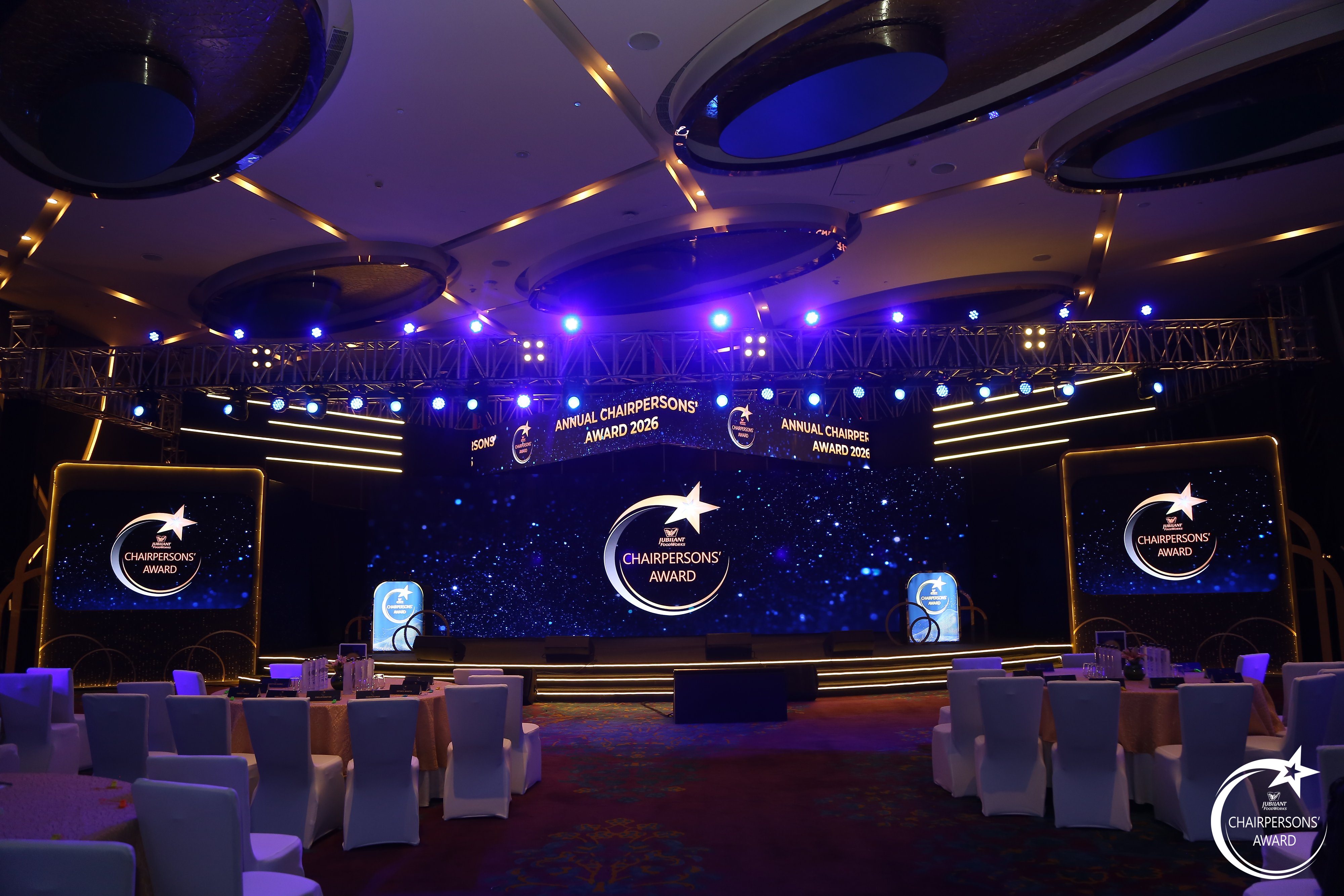 Wide view of the Chairpersons' Award ballroom set with curved starfield LED wall and banquet seating