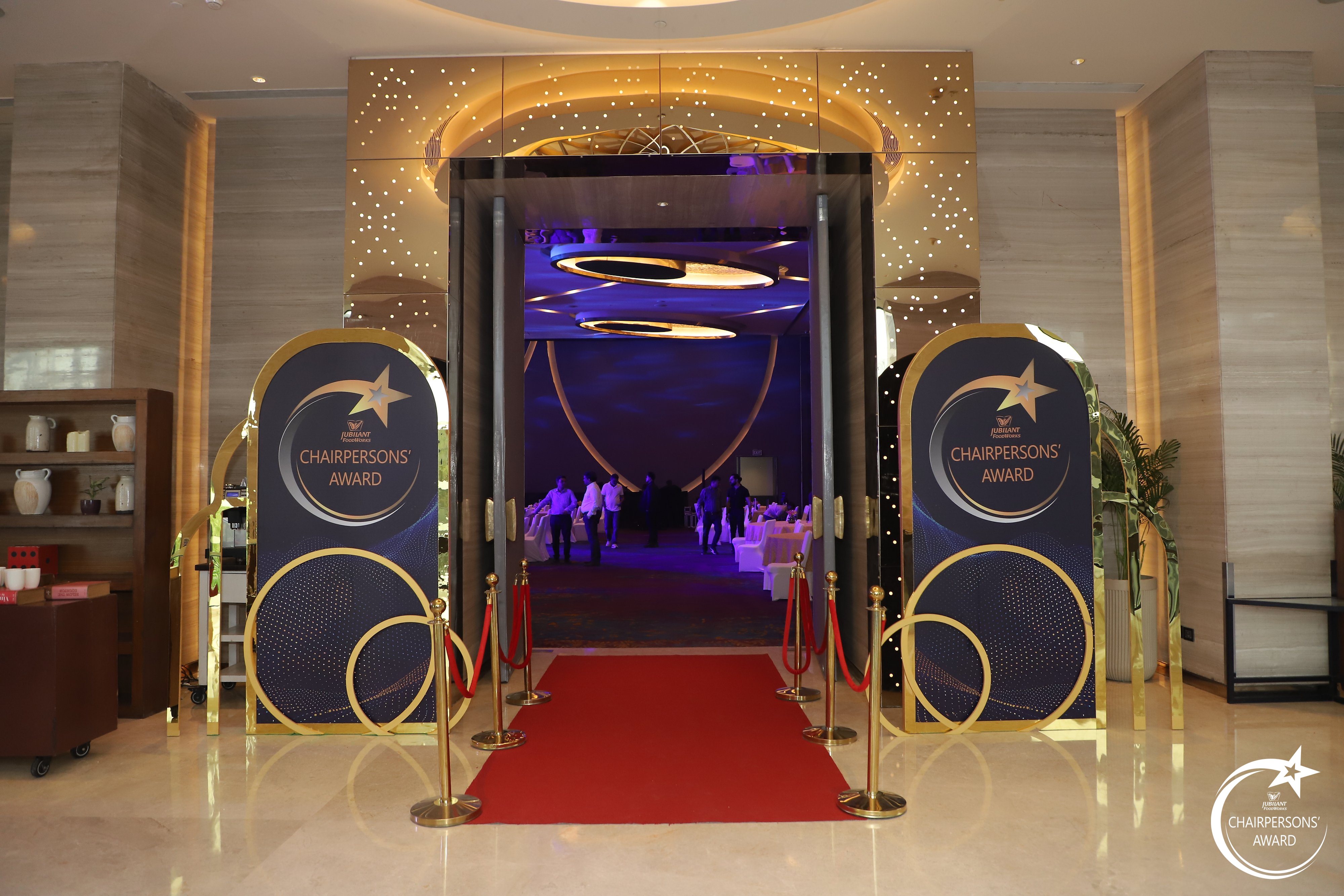 Gold portal and red-carpet entry corridor leading guests into the Chairpersons' Award ballroom