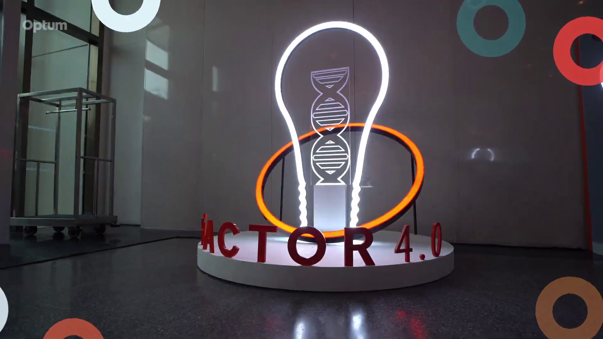 Illuminated iFactor 4.0 lightbulb sculpture and ring installation in the arrival area
