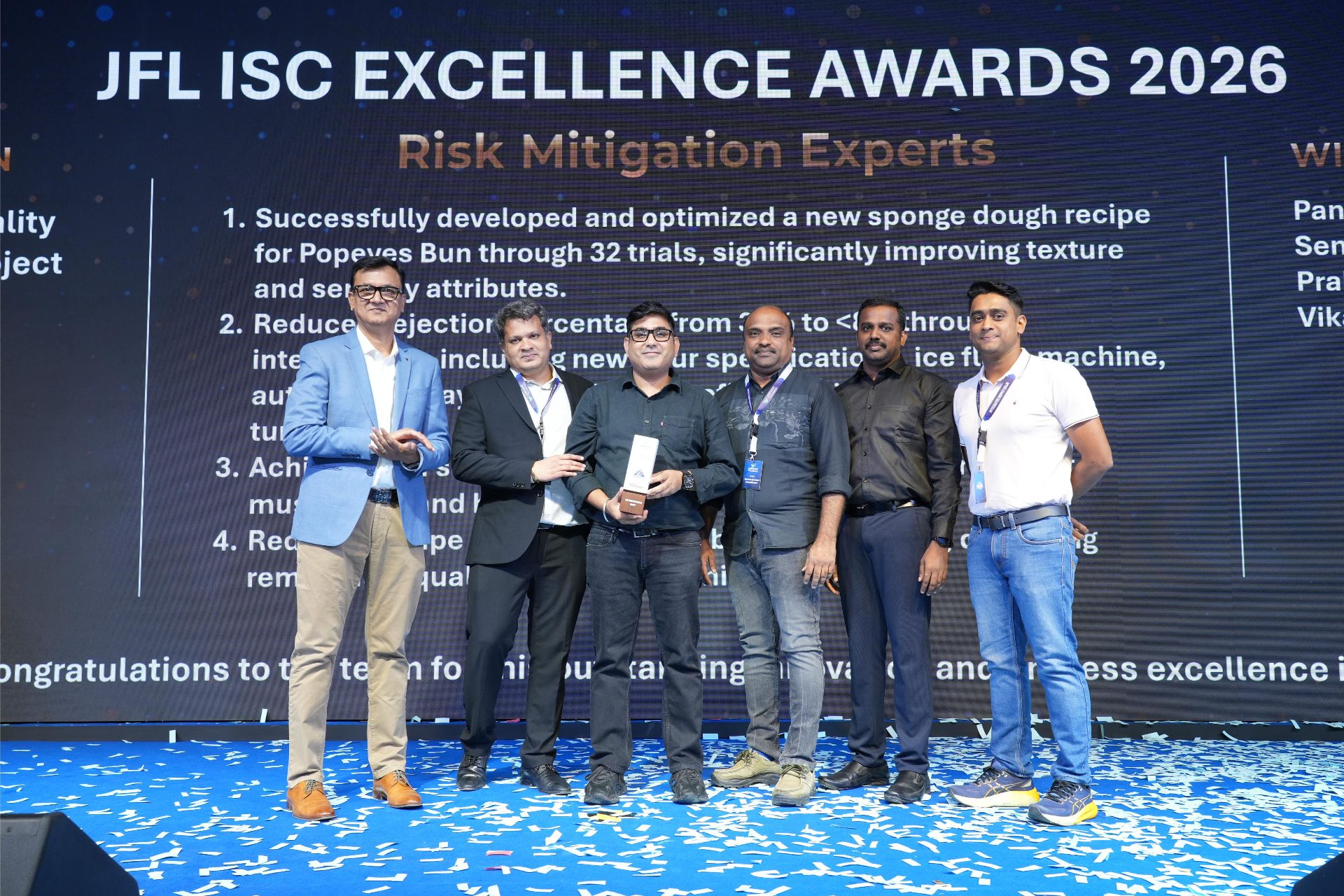 Winning team collecting a trophy amid confetti at the JFL ISC Excellence Awards 2026