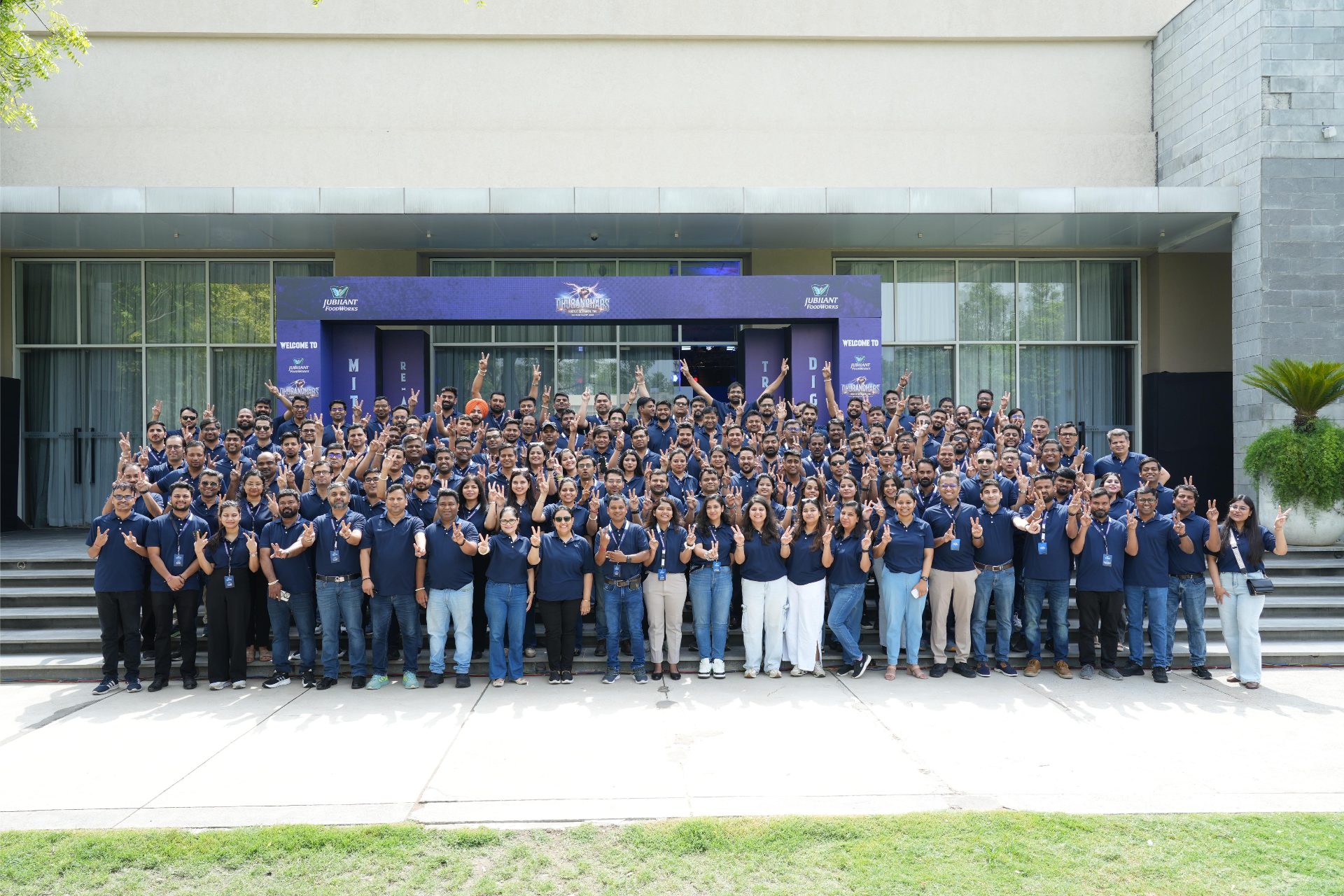 Full delegate group photograph outside the themed entrance portal at Marriott Resort Aravali